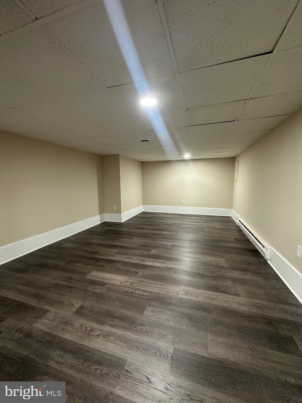2300 South 12th Street, Unit 1 Philadelphia, PA 19148 - Photo 14 of 19 an empty room with wooden floor and windows