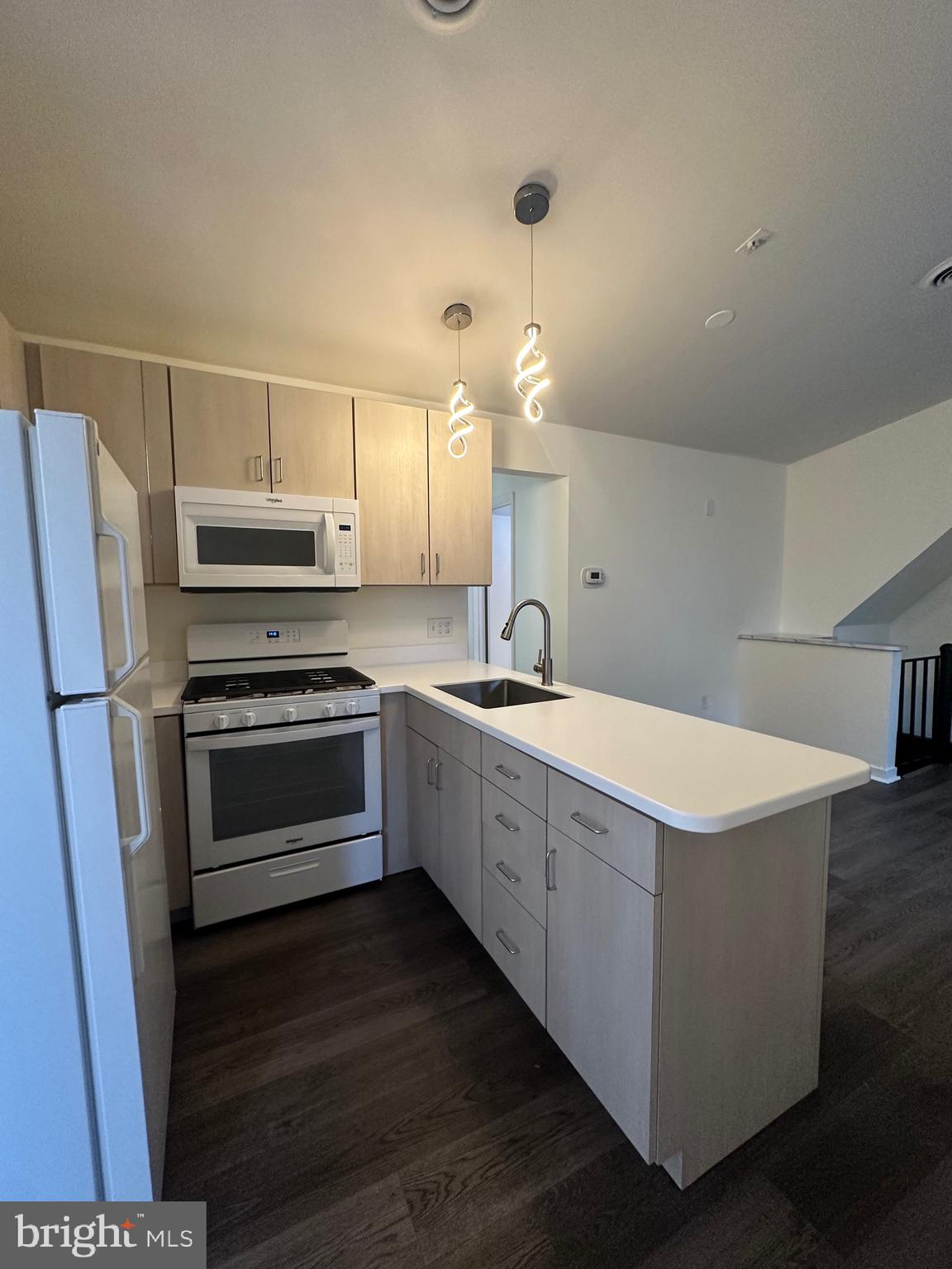 2300 South 12th Street, Unit 1 Philadelphia, PA 19148 - Photo 2 of 19 a kitchen with a white cabinets and stainless steel appliances