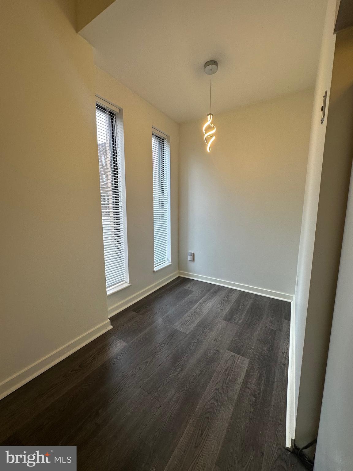 2300 South 12th Street, Unit 1 Philadelphia, PA 19148 - Photo 5 of 19 an empty room with wooden floor and windows