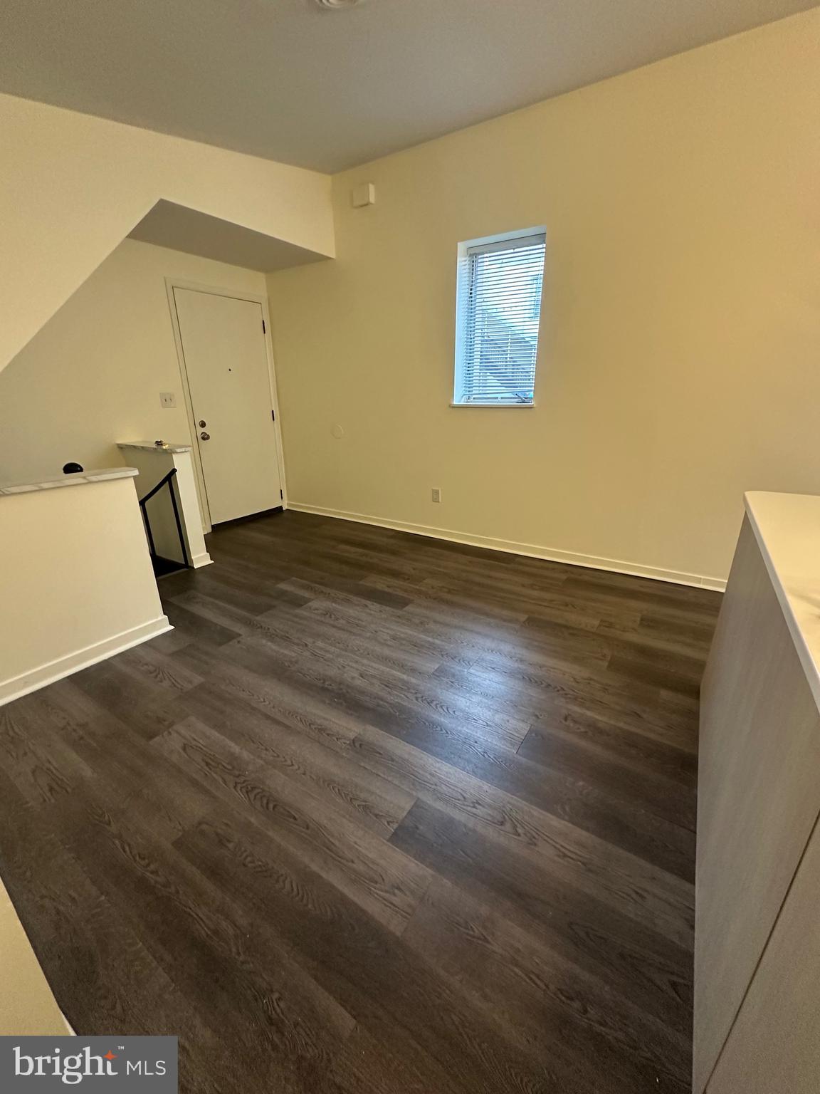 2300 South 12th Street, Unit 1 Philadelphia, PA 19148 - Photo 7 of 19 an empty room with wooden floor and windows