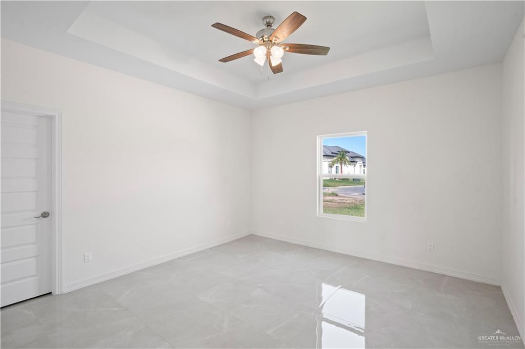 2112 North 28th Street Hidalgo, TX 78557 - Photo 12 of 22 an empty room with a window and a fan
