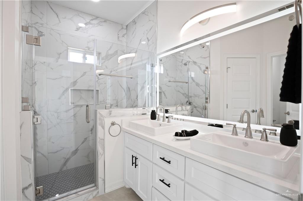 2112 North 28th Street Hidalgo, TX 78557 - Photo 17 of 22 a bathroom with a shower sink and mirror