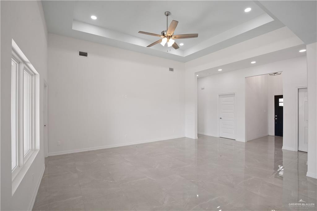 2112 North 28th Street Hidalgo, TX 78557 - Photo 3 of 22 an empty room with a ceiling fan and a window