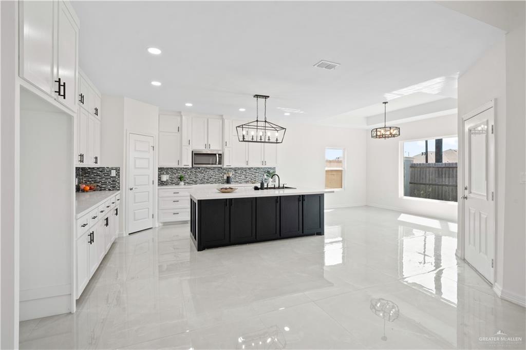 2112 North 28th Street Hidalgo, TX 78557 - Photo 6 of 22 a large white kitchen with a sink and cabinets