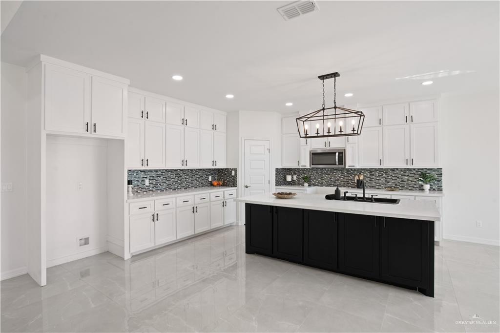 2112 North 28th Street Hidalgo, TX 78557 - Photo 7 of 22 a kitchen with granite countertop white cabinets and stainless steel appliances