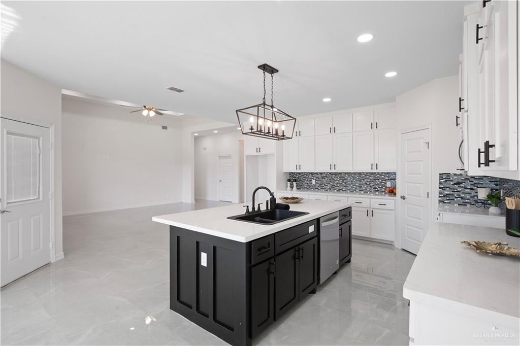 2112 North 28th Street Hidalgo, TX 78557 - Photo 8 of 22 a kitchen with a sink stove and cabinets