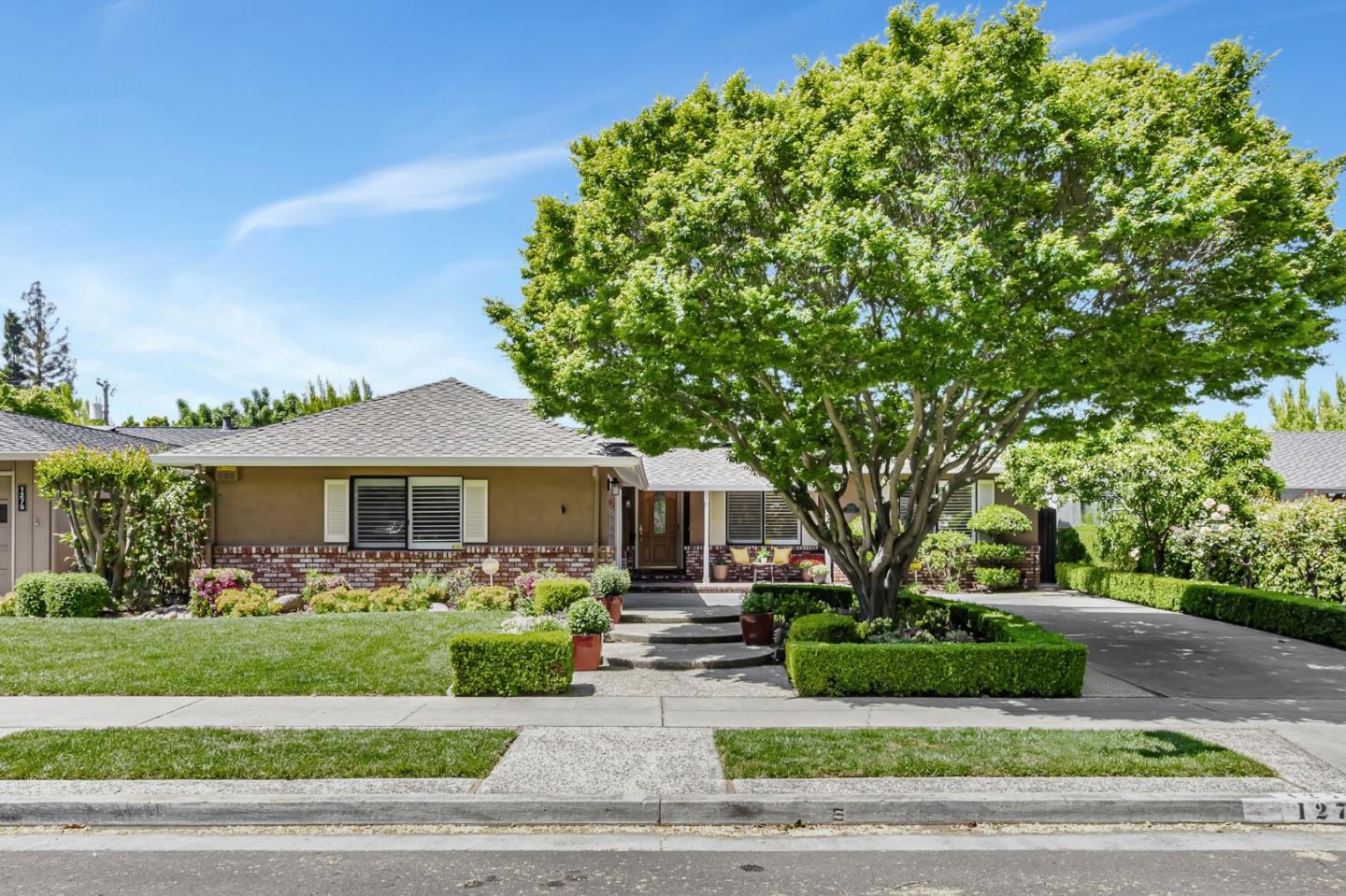 a front view of a house with a garden