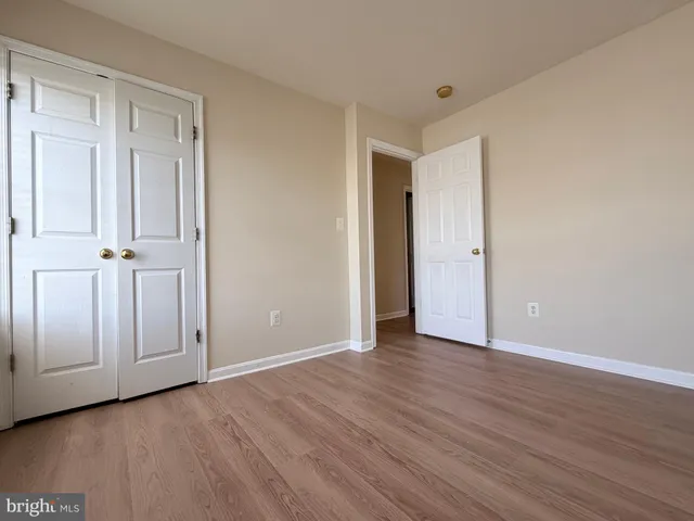 a view of an empty room and wooden floor