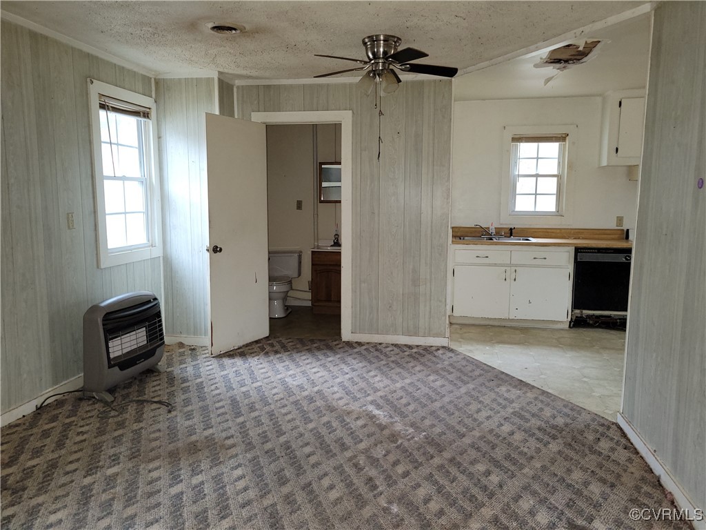 683 Oakes Landing Road Saluda, VA 23149 - Photo 22 of 29 Kitchen with heating unit, a sink, white cabinetry