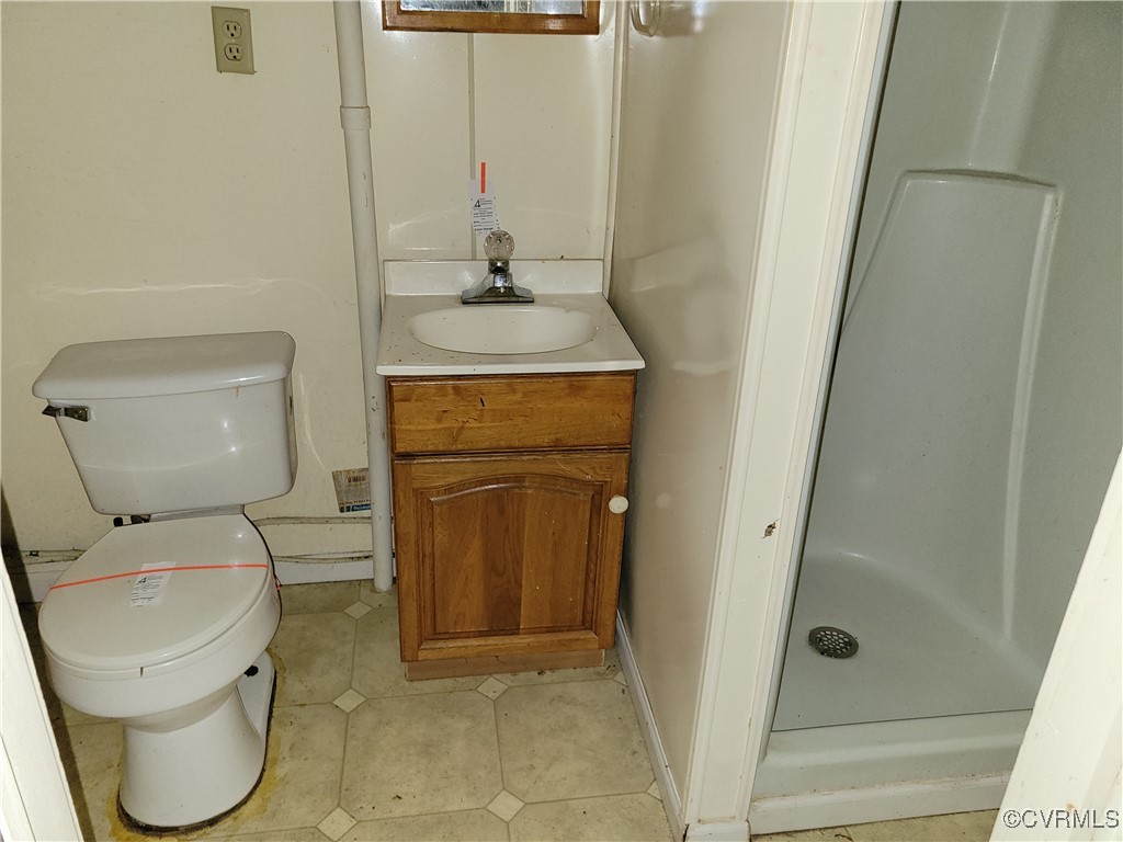 683 Oakes Landing Road Saluda, VA 23149 - Photo 26 of 29 Full bathroom with toilet, a stall shower, tile pa