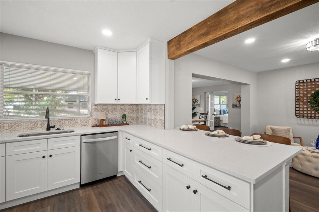 1472 Ruth Road Dunedin, FL 34698 - Photo 13 of 50 a kitchen with sink stove and cabinets