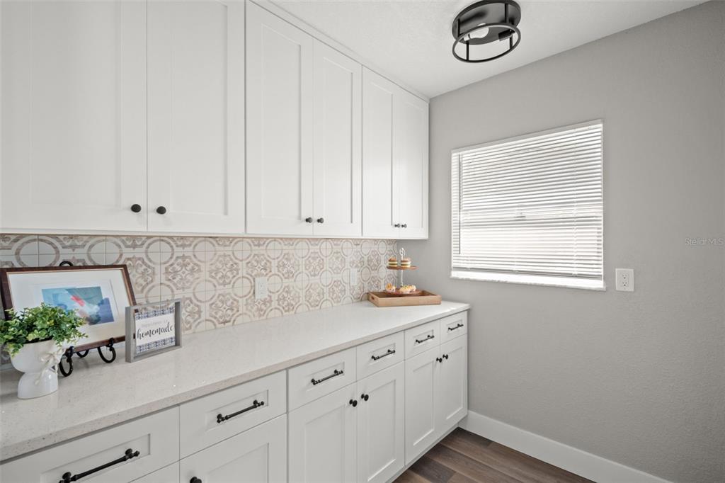 1472 Ruth Road Dunedin, FL 34698 - Photo 15 of 50 a kitchen with stainless steel appliances white cabinets and a window