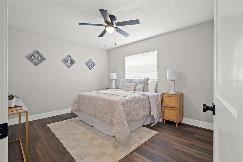 1472 Ruth Road Dunedin, FL 34698 - Photo 26 of 50 a bedroom with a bed and wooden floor