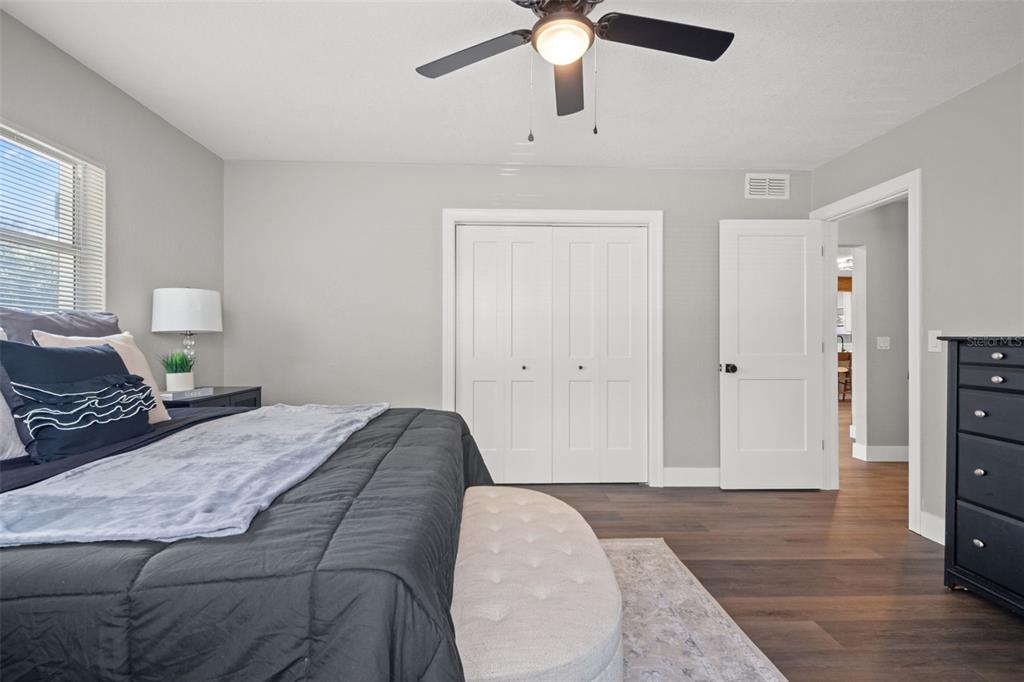 1472 Ruth Road Dunedin, FL 34698 - Photo 29 of 50 a bedroom with a bed and a chandelier