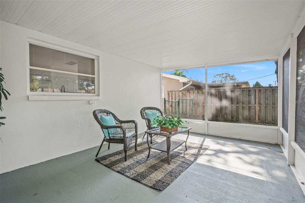 1472 Ruth Road Dunedin, FL 34698 - Photo 32 of 50 a living room with furniture and a floor to ceiling window
