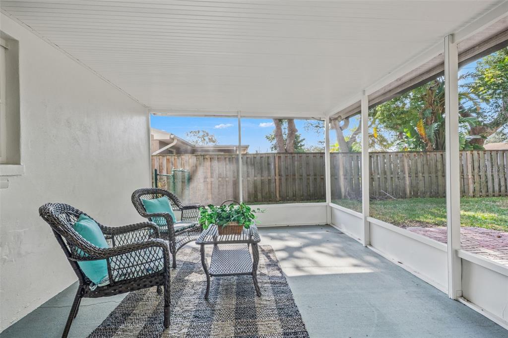 1472 Ruth Road Dunedin, FL 34698 - Photo 33 of 50 a view of a patio with a table and chairs