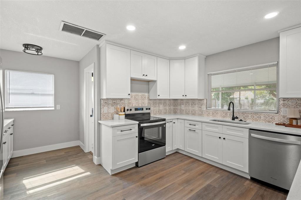 1472 Ruth Road Dunedin, FL 34698 - Photo 10 of 50 a kitchen with a sink stove and cabinets