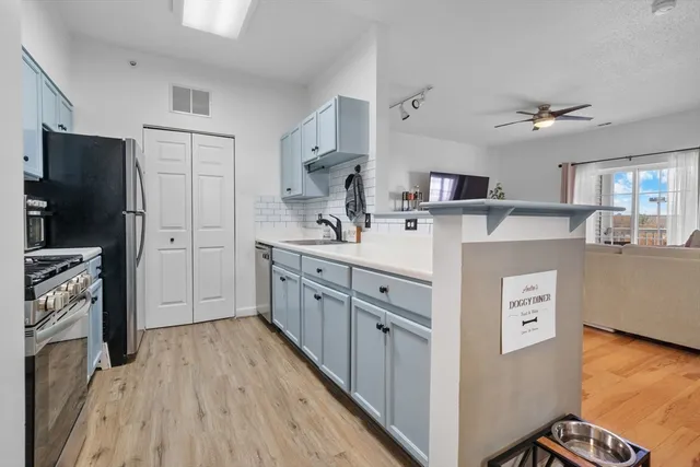 a kitchen with stainless steel appliances granite countertop a sink and a stove
