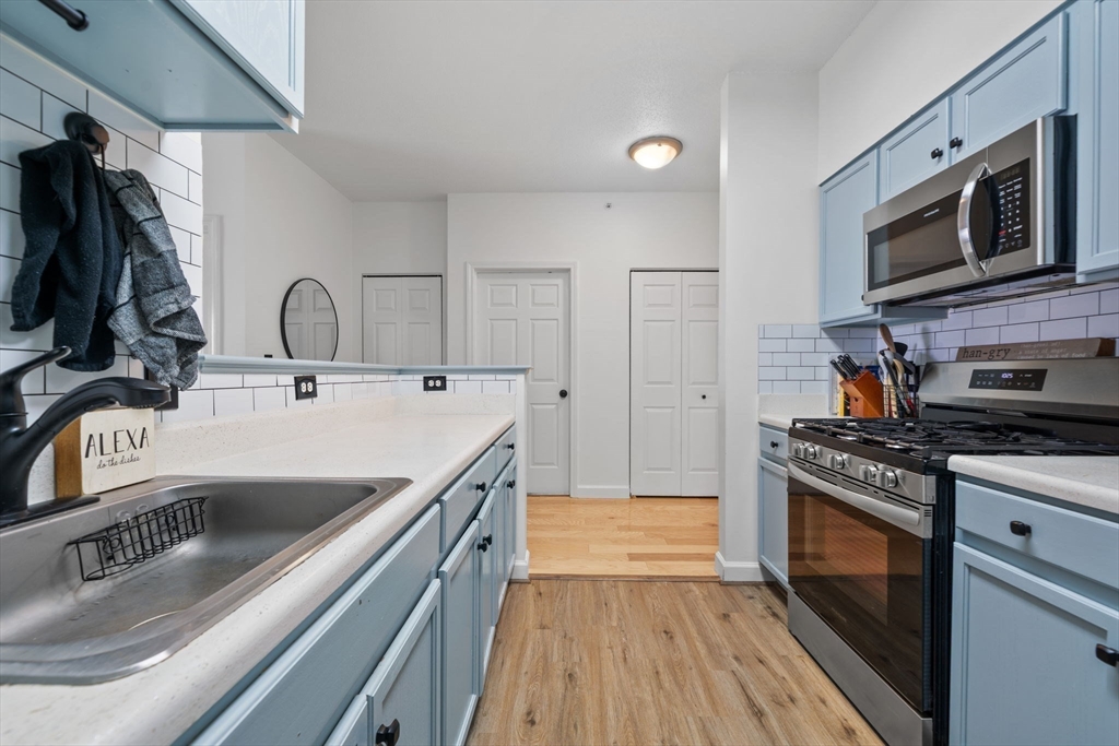 21 Hampshire Road, Unit 412 Methuen, MA 01844 - Photo 13 of 37 a kitchen with stainless steel appliances granite countertop a sink and a stove