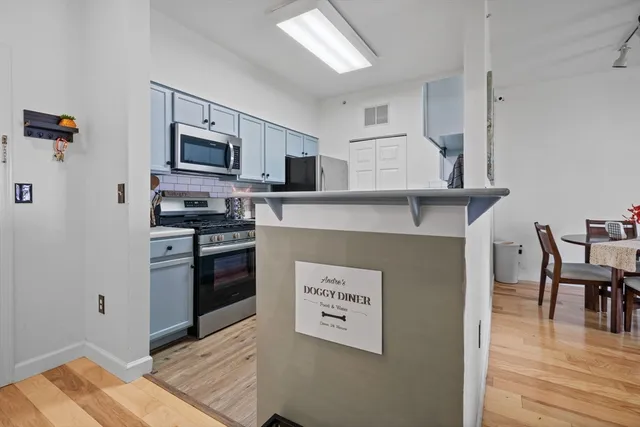 a living room with furniture a flat screen tv and a large window
