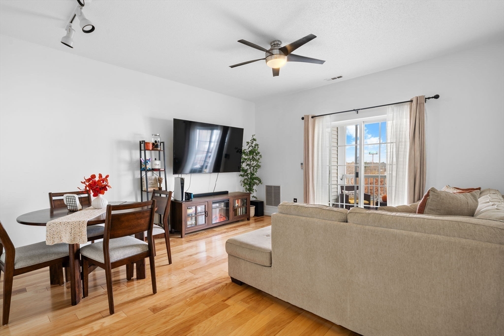 21 Hampshire Road, Unit 412 Methuen, MA 01844 - Photo 15 of 37 a living room with furniture a flat screen tv and a large window