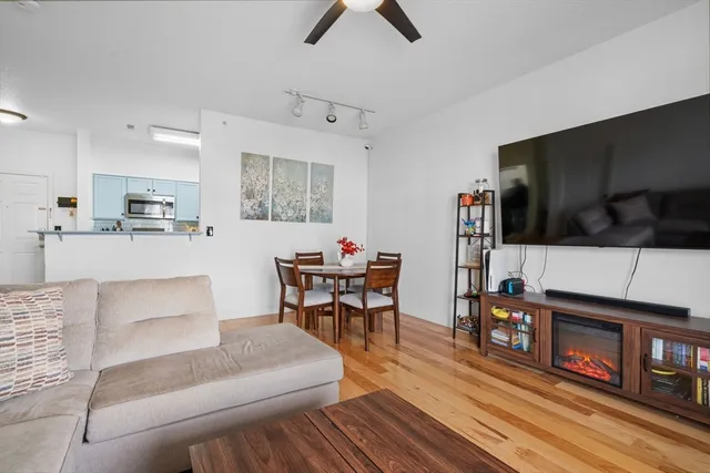 a dining room with furniture and wooden floor