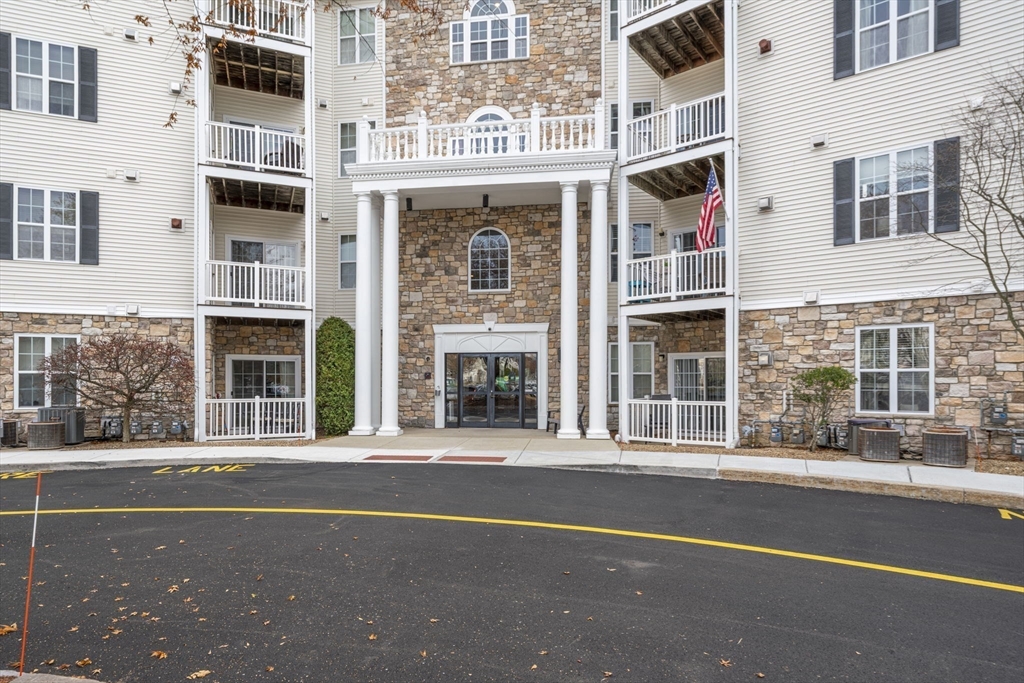 21 Hampshire Road, Unit 412 Methuen, MA 01844 - Photo 2 of 37 a front view of a building with a glass windows