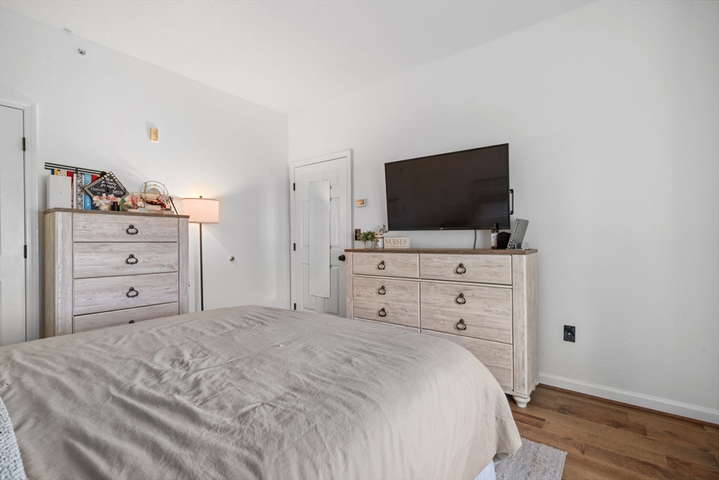 21 Hampshire Road, Unit 412 Methuen, MA 01844 - Photo 25 of 37 a bedroom with a bed and a flat screen tv