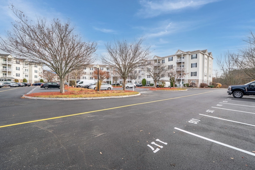 21 Hampshire Road, Unit 412 Methuen, MA 01844 - Photo 35 of 37 a city street lined with buildings and cars