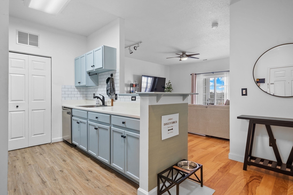 21 Hampshire Road, Unit 412 Methuen, MA 01844 - Photo 8 of 37 a kitchen with stainless steel appliances a stove a sink cabinets and wooden floor