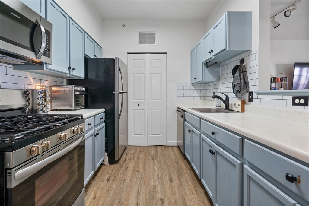 21 Hampshire Road, Unit 412 Methuen, MA 01844 - Photo 9 of 37 a kitchen with stainless steel appliances a sink dishwasher stove and refrigerator