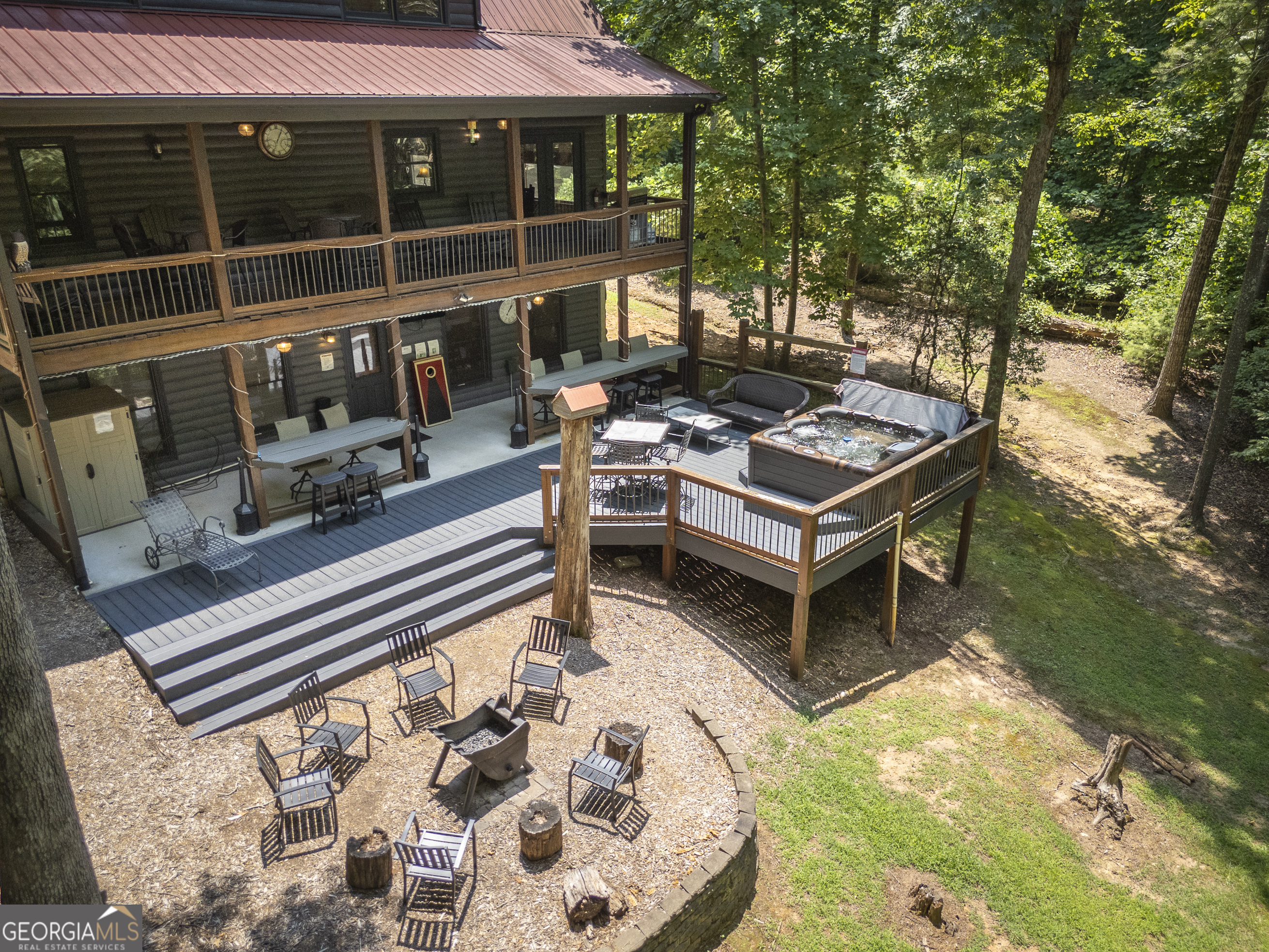a backyard of a house with barbeque oven fire pit table and chairs