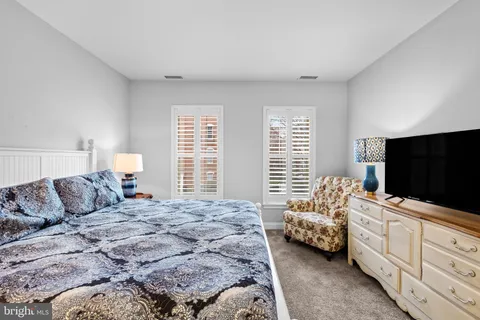 a bedroom with furniture and a flat screen tv