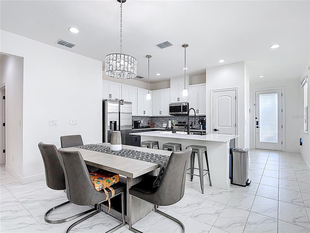 7541 Wing Span Way Harmony, FL 34773 - Photo 11 of 49 a view of kitchen with cabinets table and chairs