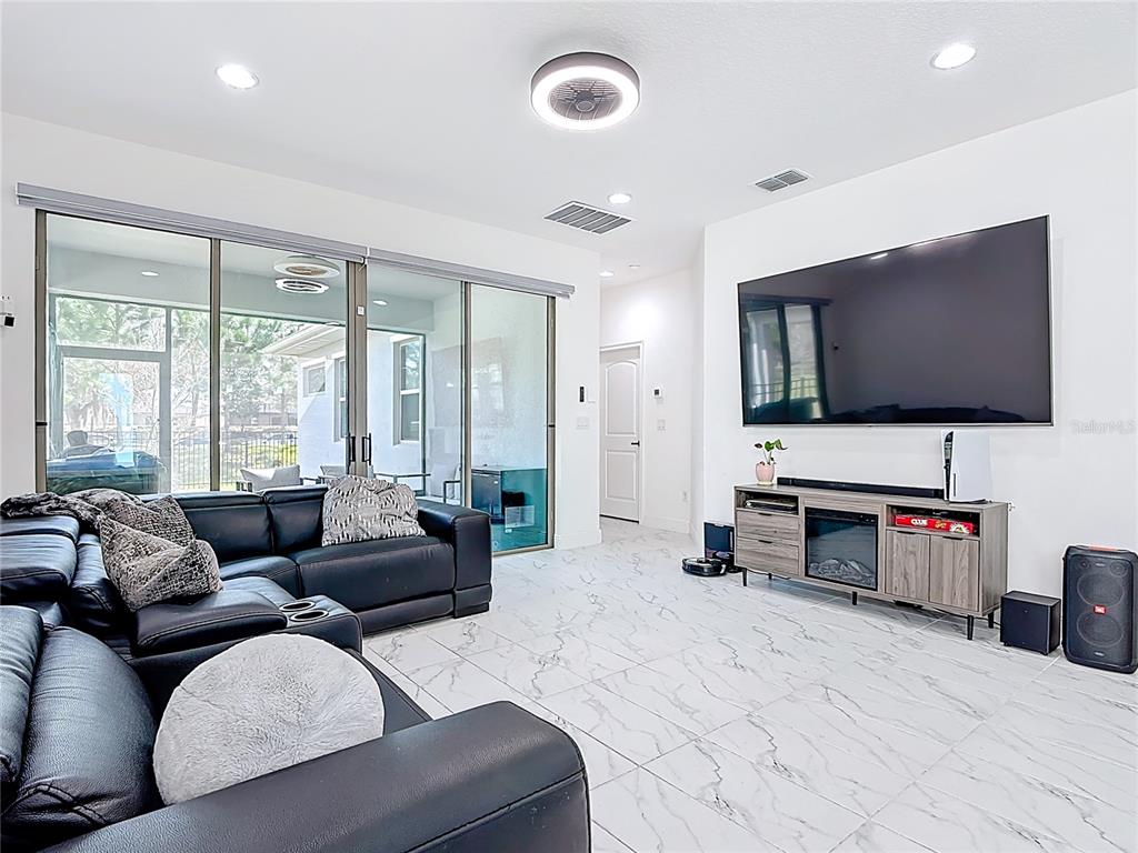 7541 Wing Span Way Harmony, FL 34773 - Photo 14 of 49 a living room with furniture and a flat screen tv