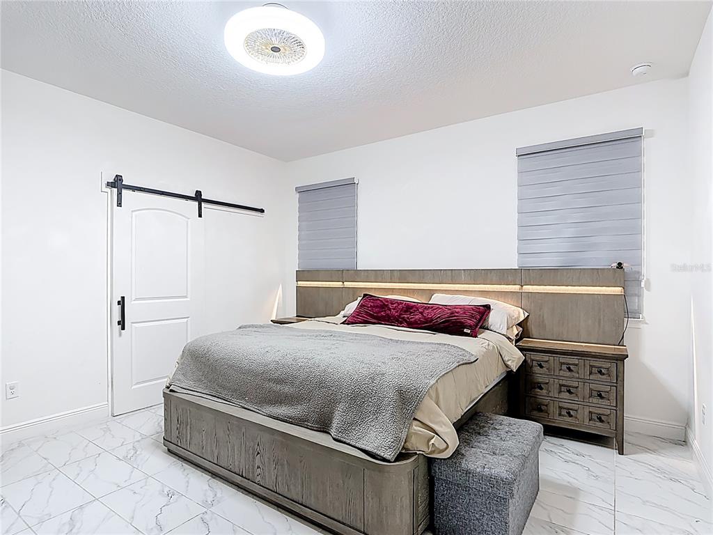 7541 Wing Span Way Harmony, FL 34773 - Photo 17 of 49 a bedroom with a bed and a table