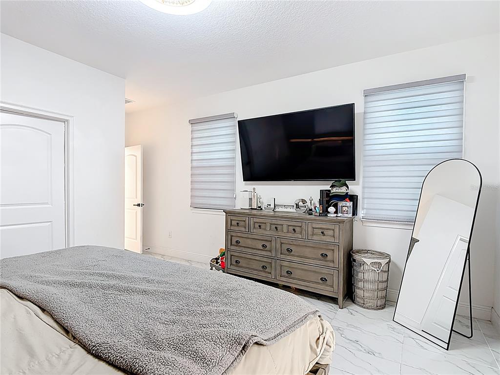 7541 Wing Span Way Harmony, FL 34773 - Photo 19 of 49 a living room with furniture and a flat screen tv