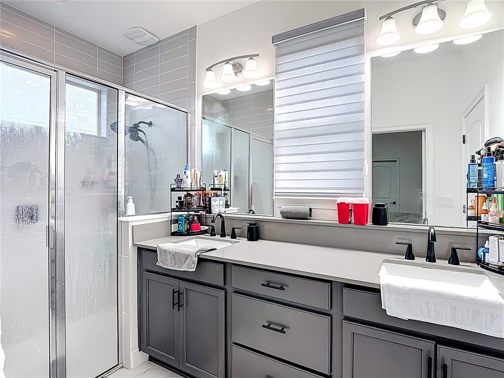 7541 Wing Span Way Harmony, FL 34773 - Photo 20 of 49 a bathroom with a sink and a mirror