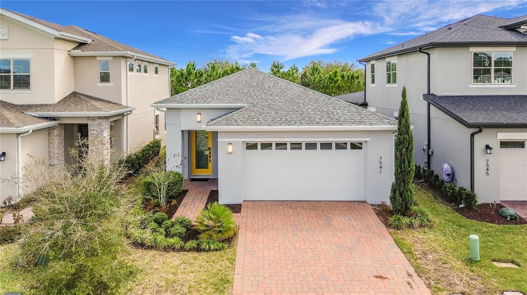 7541 Wing Span Way Harmony, FL 34773 - Photo 2 of 49 a view of a house with a yard and plants
