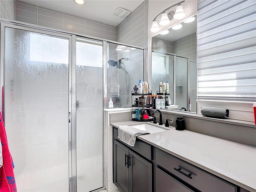 7541 Wing Span Way Harmony, FL 34773 - Photo 21 of 49 a bathroom with a sink and a mirror