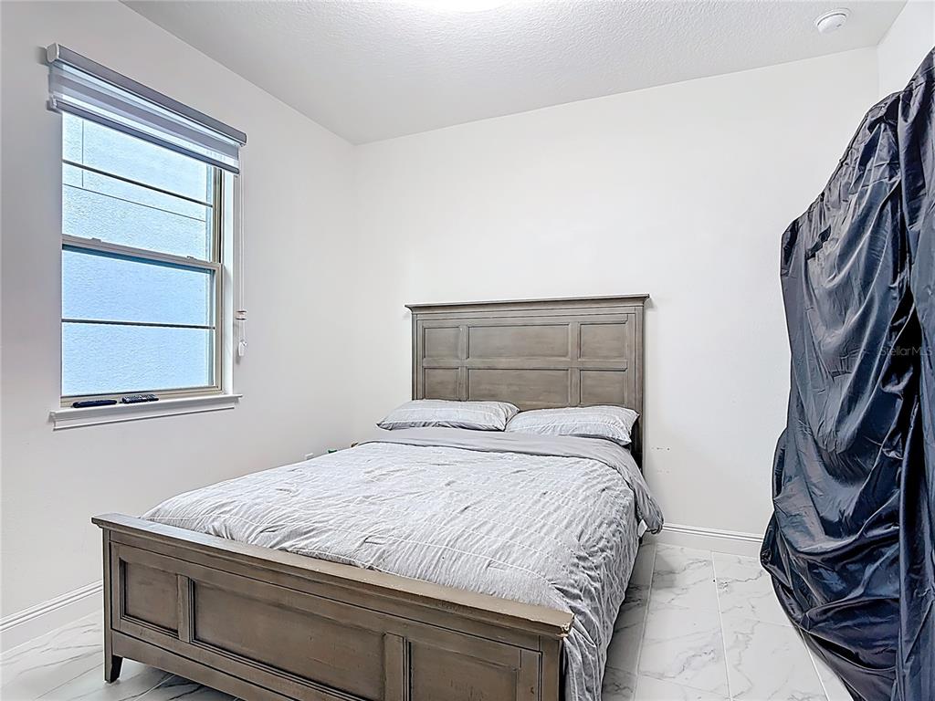 7541 Wing Span Way Harmony, FL 34773 - Photo 23 of 49 a bedroom with a bed and a window