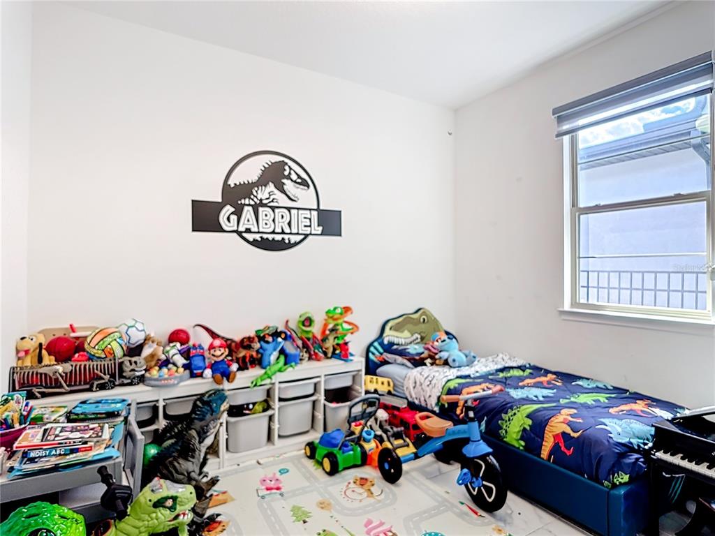 7541 Wing Span Way Harmony, FL 34773 - Photo 24 of 49 a bed room with lots of different kinds of flowers