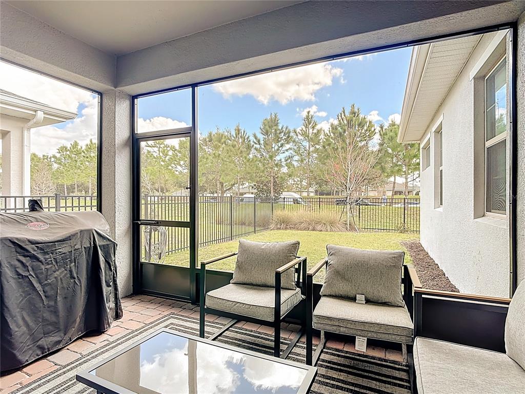 7541 Wing Span Way Harmony, FL 34773 - Photo 30 of 49 a balcony with furniture and wooden floor