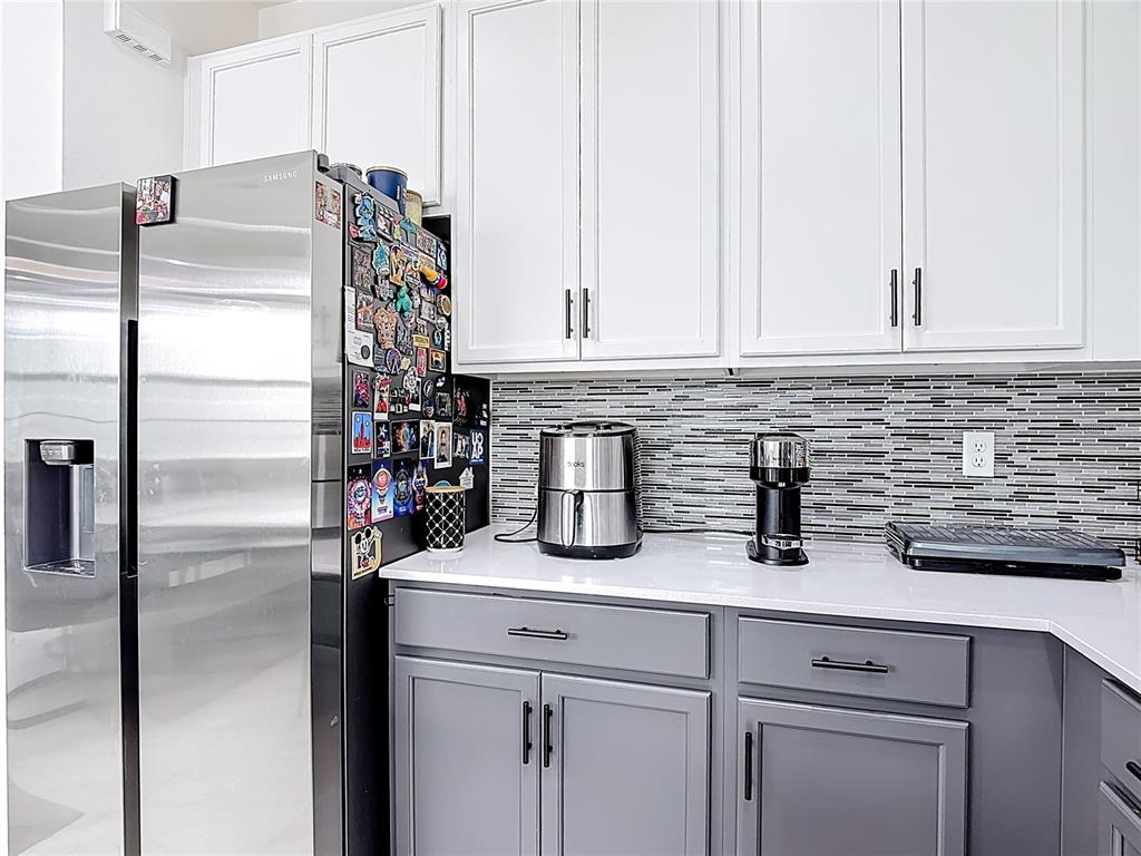 7541 Wing Span Way Harmony, FL 34773 - Photo 10 of 49 a kitchen with appliances and cabinets