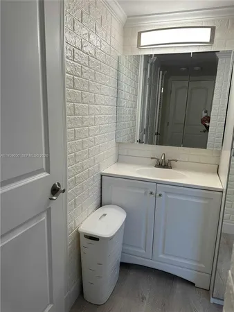 a bathroom with a sink and mirror
