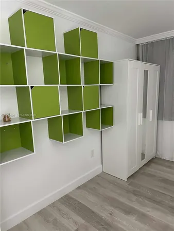 a view of a room with wooden floor and windows