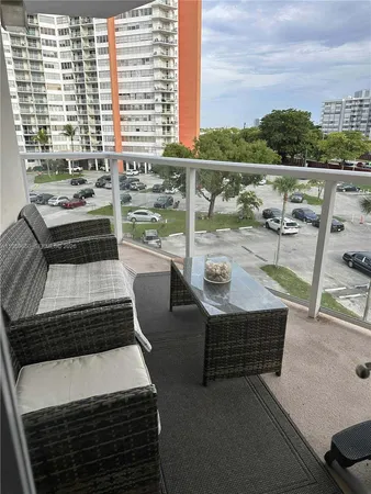 a view of roof deck with outdoor seating and city view
