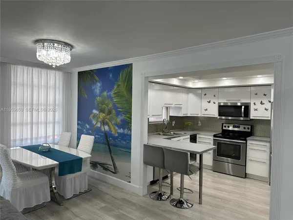 a kitchen with a counter space a sink appliances and cabinets