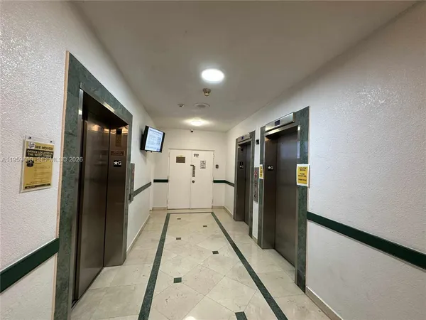 a view of a refrigerator in kitchen and wooden floor