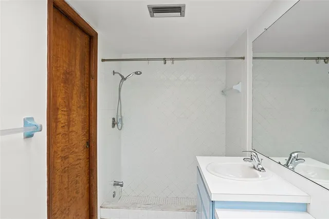 a bathroom with a shower and a sink
